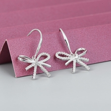 Show details for Delicate White Dangle Earrings of Original Design